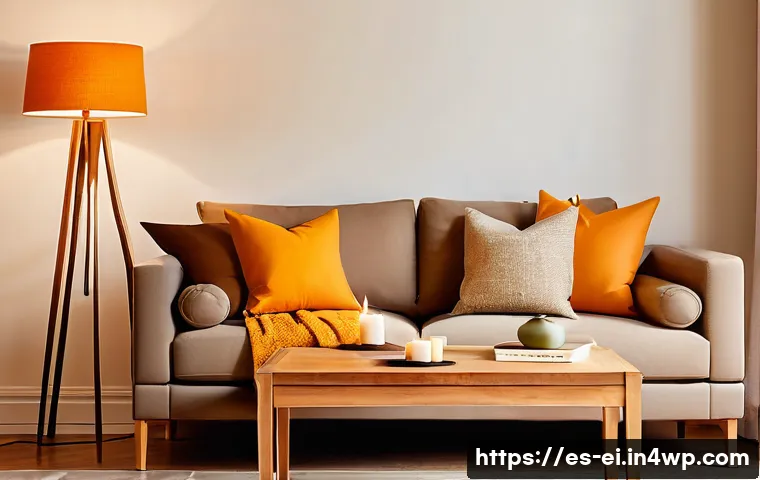 조명으로 만드는 스트레스 없는 공간 - A cozy living room interior featuring warm yellow and orange ambient lighting from a tall fabric-sha...
